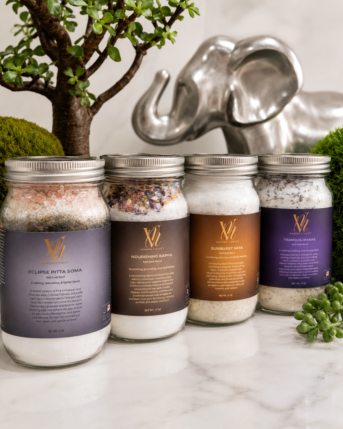 Moksha Vitality Soma bath soak jars displayed with mineral salts, botanicals, and spa-inspired decor.